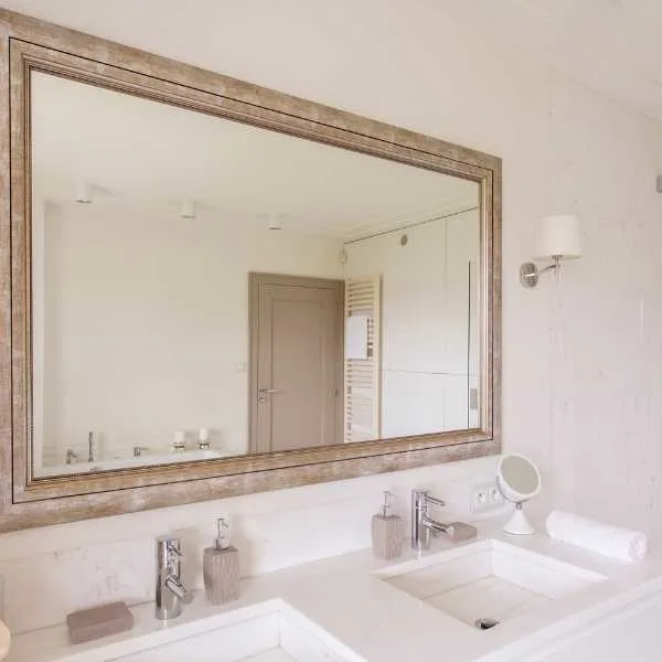 Small bathroom with large mirror.