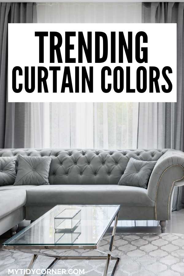 Living room with gray couch and curtains and text overlay that says, "Trending curtain colors".