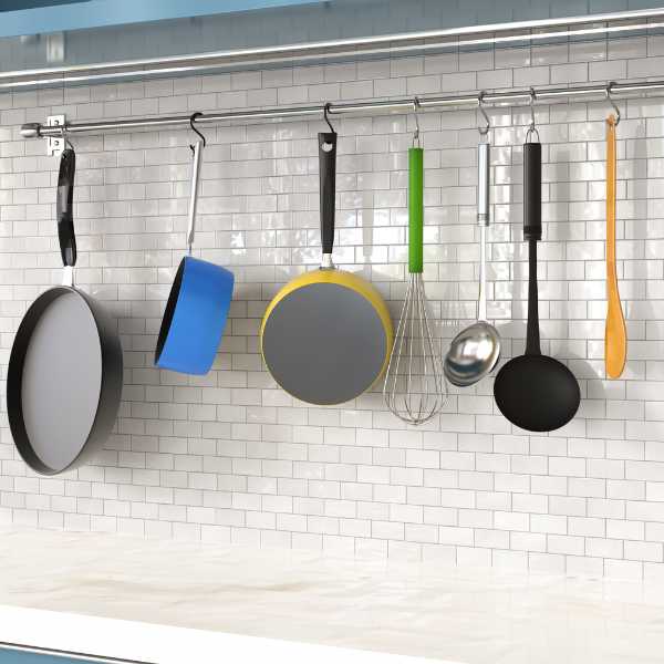 Cookware hanging on a kitchen wall.