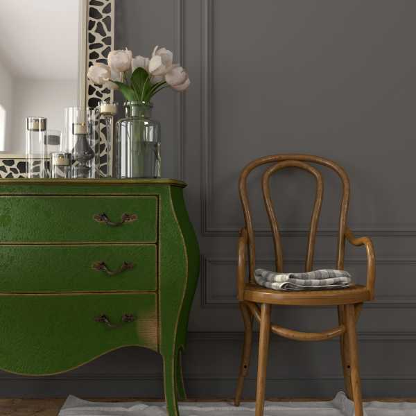 Green dresser and chair against gray wall.