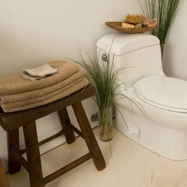 Towels on a stool in a bathroom.