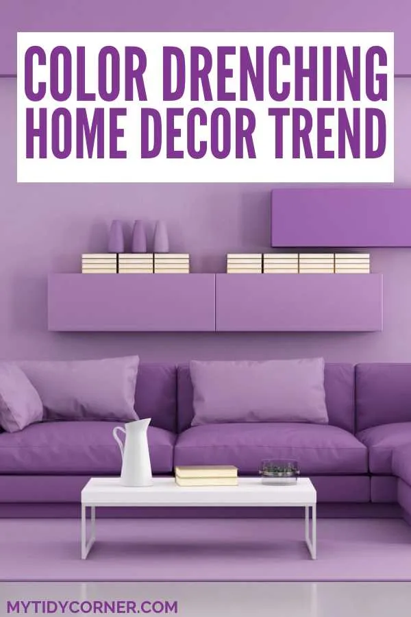 Ready to try the color drenching trend? Discover the power of color drenching! Get expert tips on how to infuse your rooms with rich, immersive shades for a dramatic, unified look. Perfect for those who love bold interior design. Purple living room and text overlay that says, "Color drenching home decor trend".