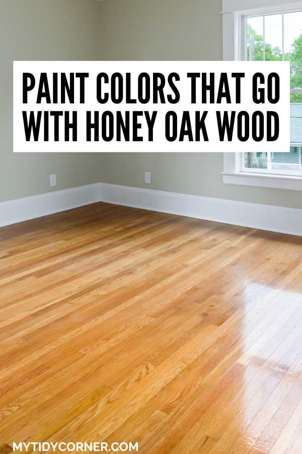 Room with wood floor and gray wall text overlay that says, "Paint colors that go with honey oak wood".