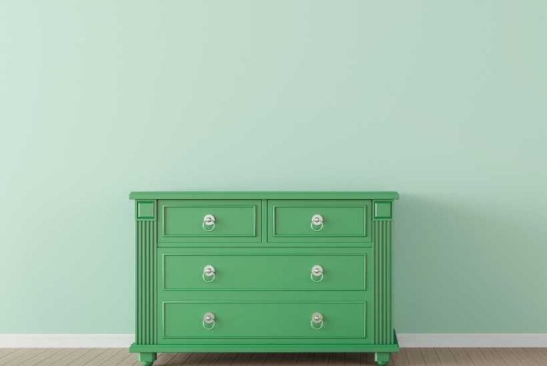 Room with green wall, green chest - Featured image for "Green paint colors for low light rooms" blog post.